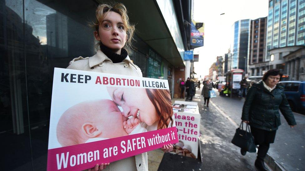 An anti-abortion campaigner outside an abortion clinic in Belfast