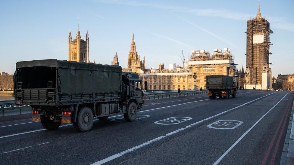 Military vehicles cross Westminster Bridge after members of the 101 Logistic Brigade delivered a consignment of medical masks to St Thomas' Hospital