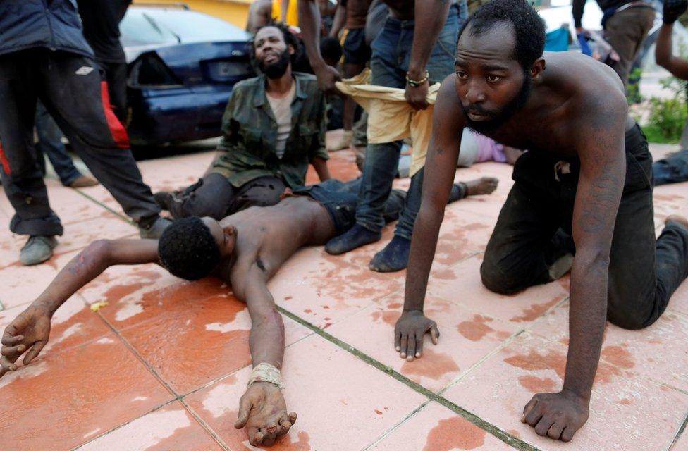 African migrants rest after crossing a border fence between Morocco and Spain"s north African enclave of Ceuta October 31, 2016