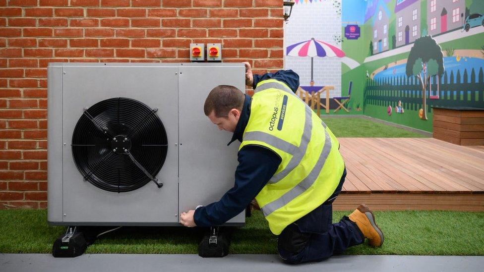 man-installing-heat-pump.