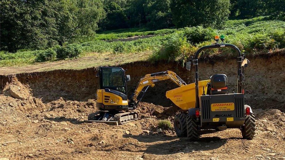 Diggers on the site of a torn up field