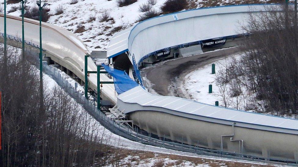 A tarp covers the intersection of the bobsled and luge tracks at Canada Olympic Park in Calgary, Canada