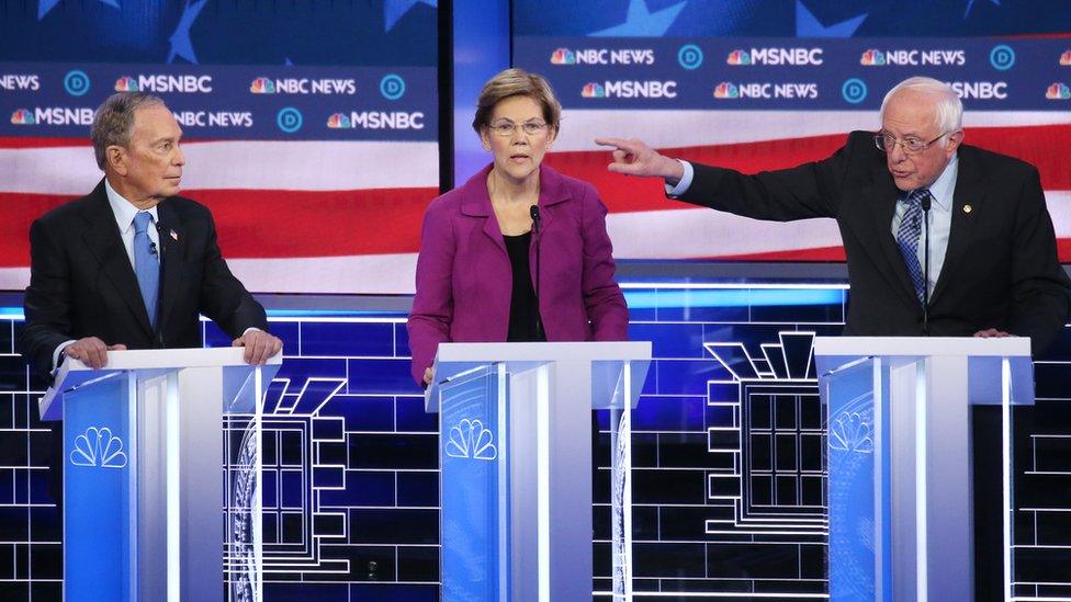 Mike Bloomberg, left, Elizabeth Warren, middle, and Bernie Sanders, right, on the debate stage.