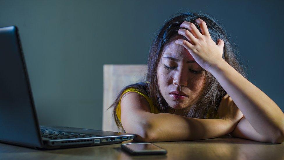 Upset woman in front of phone