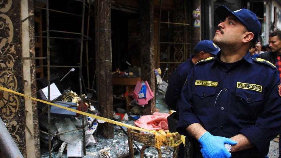 Security personnel investigate the scene of a bomb explosion outside the Saint Mark's Coptic Cathedral in Alexandria