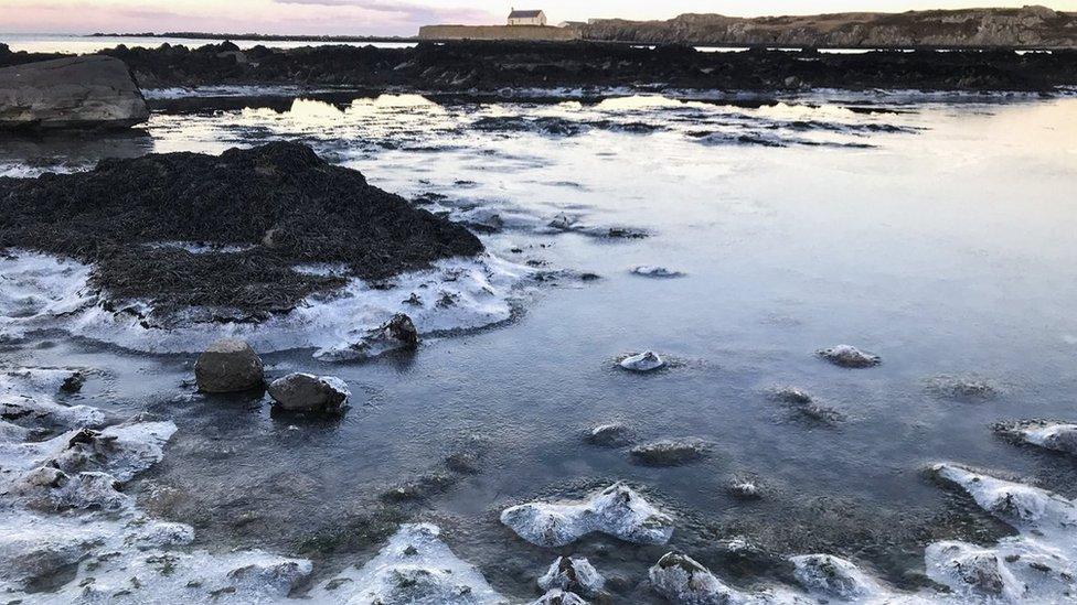 Frozen sea at Porth Cwyfan bay on Anglesey