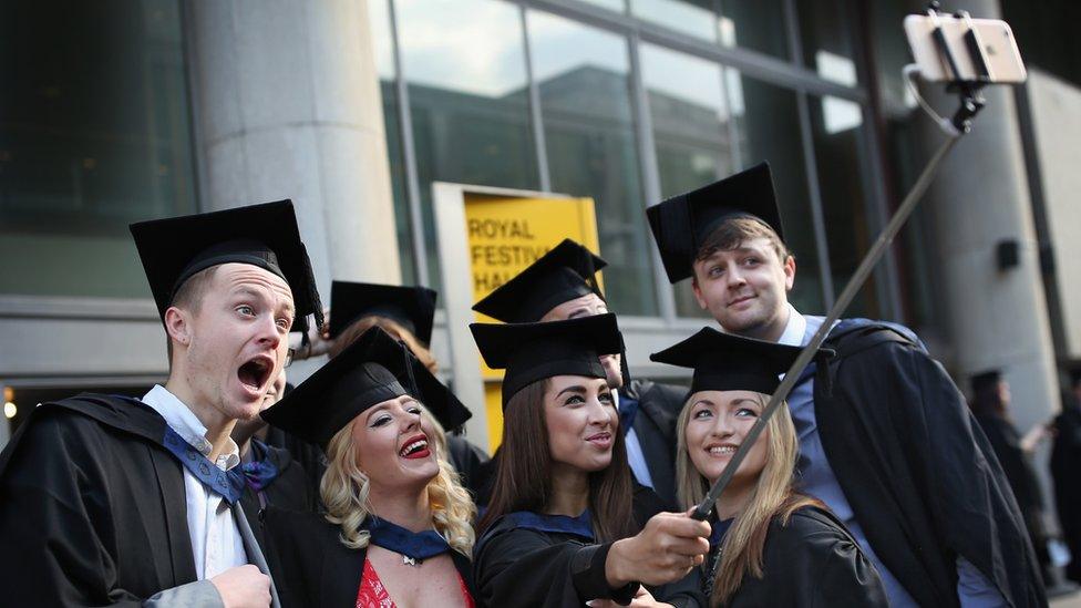 Students take selfie at graduation