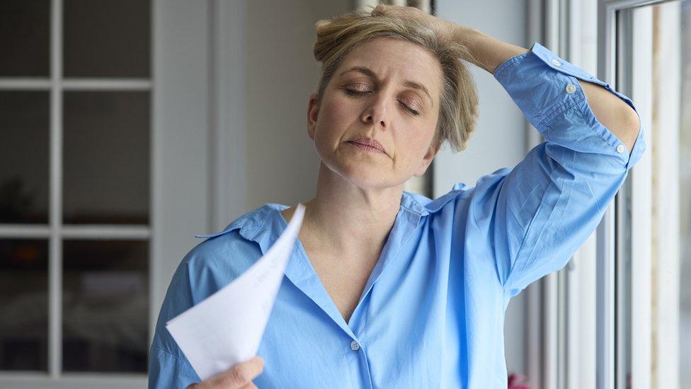 Flushed woman fanning herself