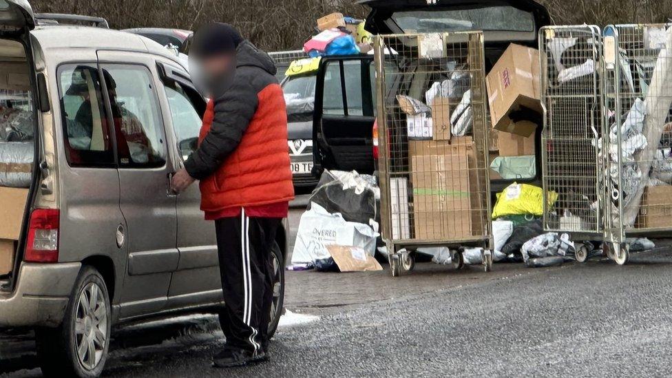 A courier loads his vehicle up