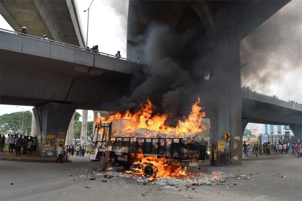 A truck from neighbouring state Tamil Nadu burns after it was set alight by agitated pro-Karnataka activists as the Cauvery water dispute erupted following the Supreme Court"s order to release water to Tamil Nadu, in Bangalore on September 12,2016