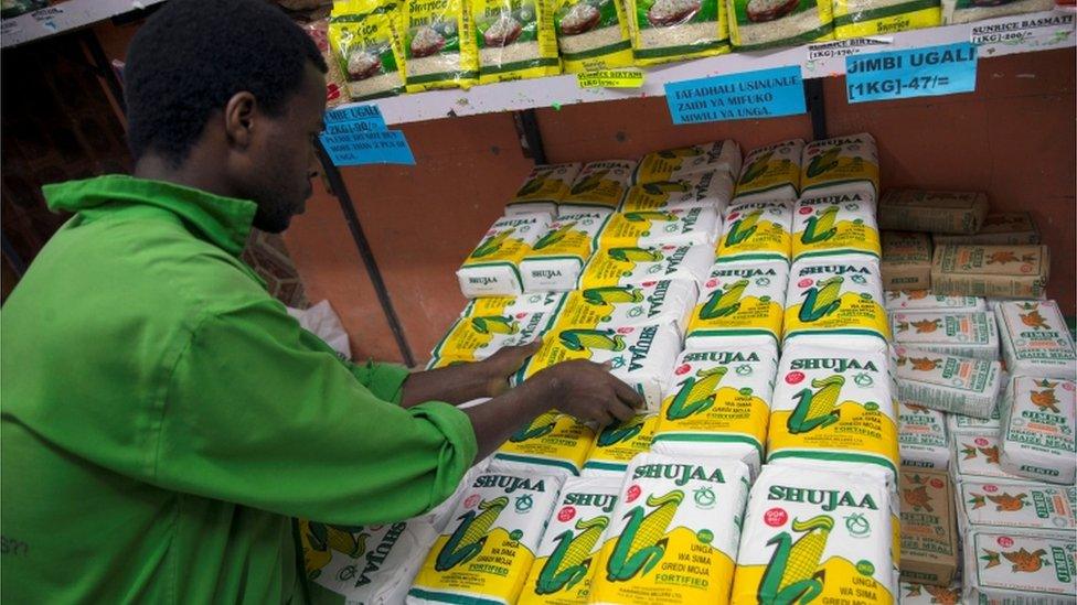 An employee restocks packet of maize flour subsidised by government at a supermarket in Nairobi, Kenya May 24, 2017