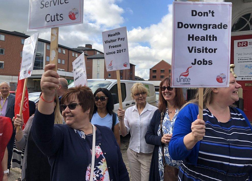 Women holding up placards