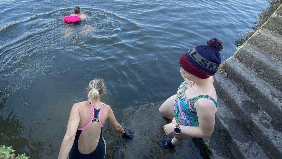 Swimmers entering water