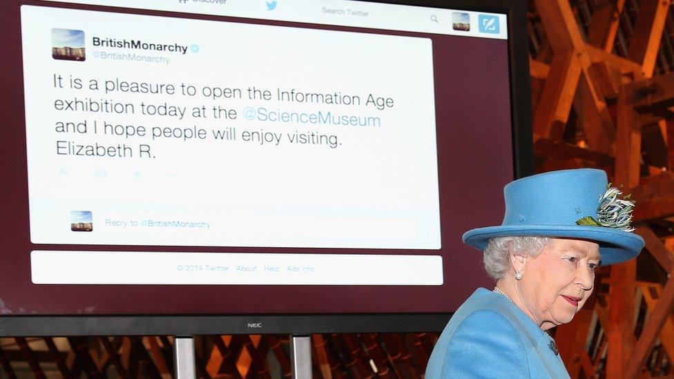 Queen alongside screen showing tweet