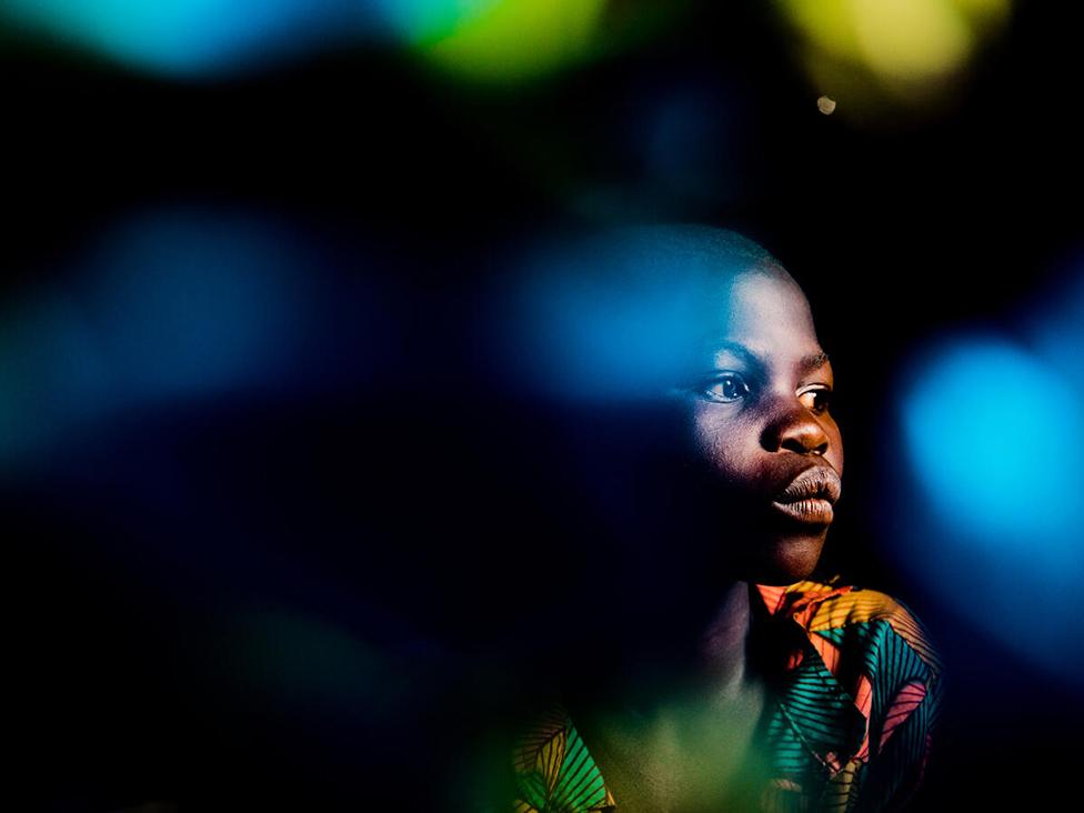 Veronique, 12, sits for a portrait at a camp for displaced people in Djugu Territory, Ituri province, DR Congo.