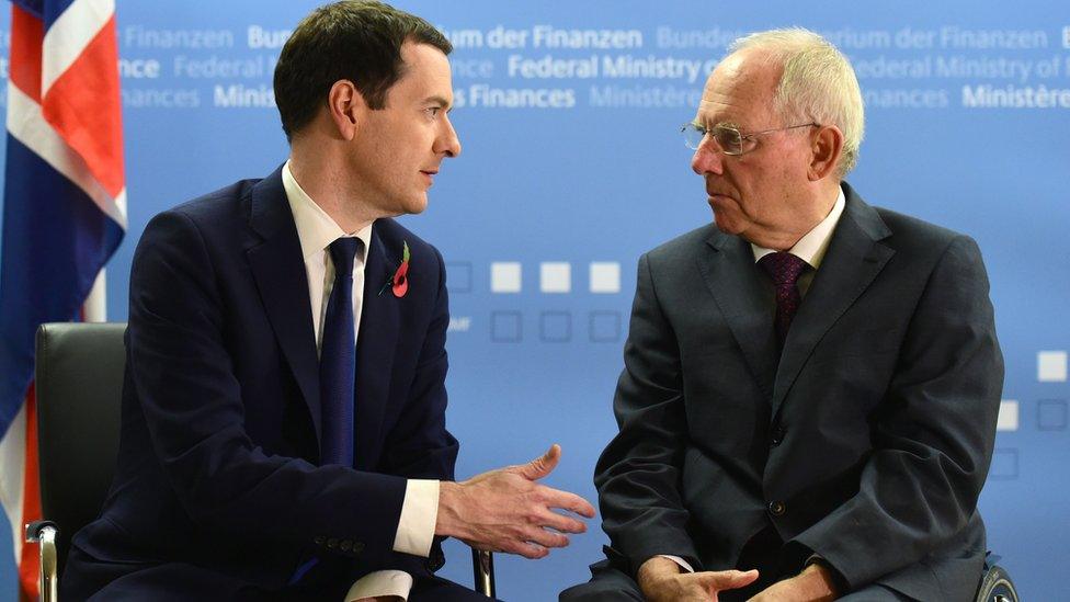 Wolfgang Schauble (R) talks with British Chancellor of the Exchequer George Osborne