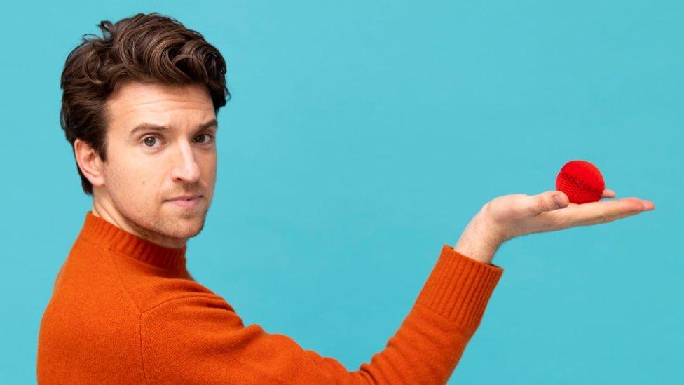 Greg James holds new Red Nose Day nose