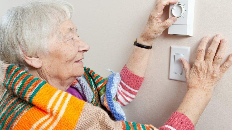 woman using thermostat