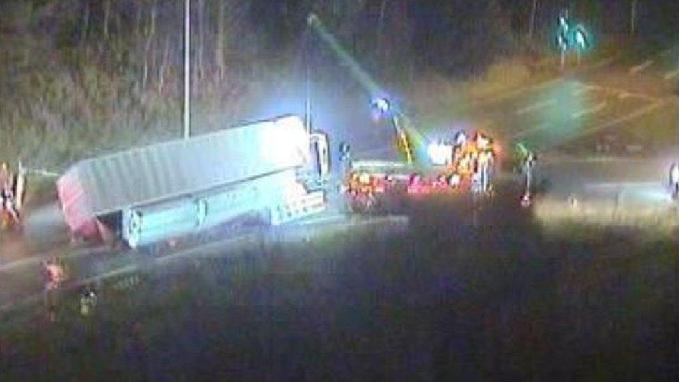 Lorry on its side on a road