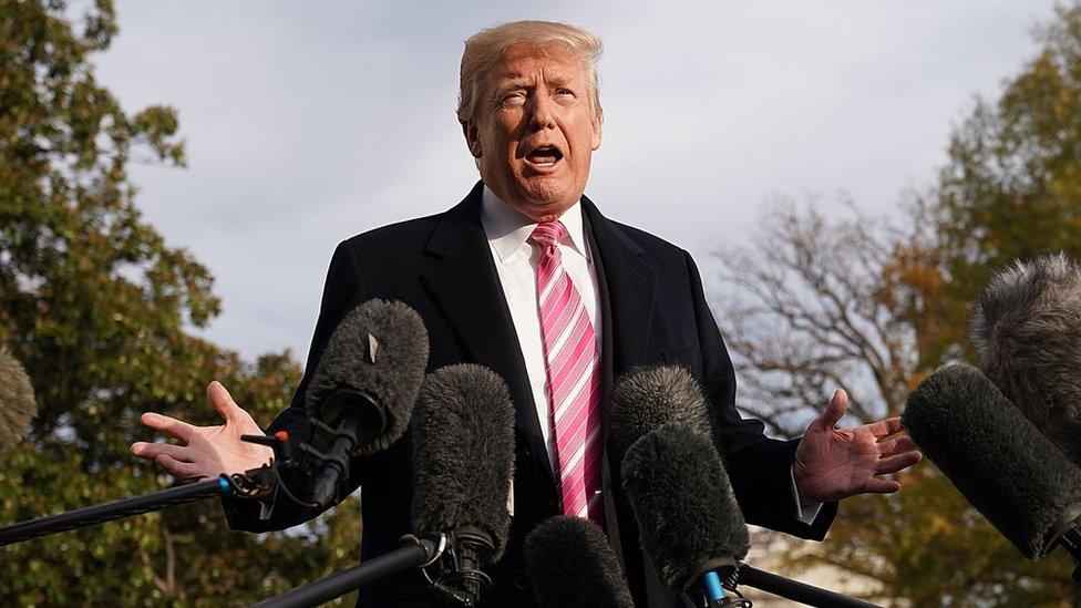 US President Donald Trump talks to reporters as he departs the White House