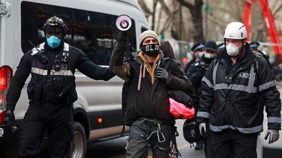 Activist led away by officers