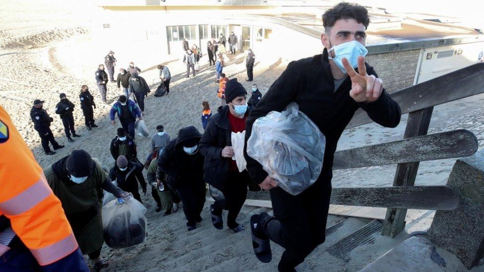 Migrants are evacuated after being rescued while trying to cross the Channel, in Berck, France, January 14, 2022