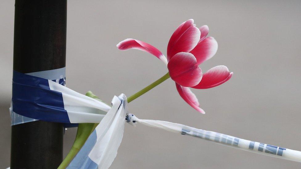 A flower tied to police tape outside the Queen Elizabeth II Centre in London