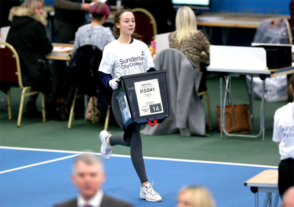 Woman carrying a ballot box