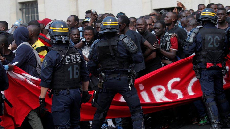 Undocumented migrants are surrounded by police after having occupied the Panthéon in Paris, 12 July 2019