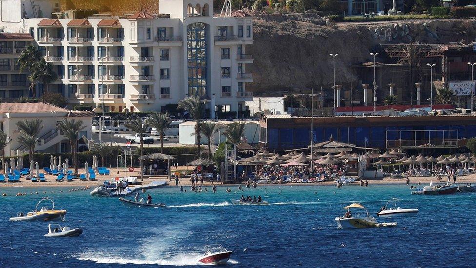 Tourists enjoy the water on a beach at the Red Sea resort of Sharm el-Sheikh, south of Cairo, Egypt