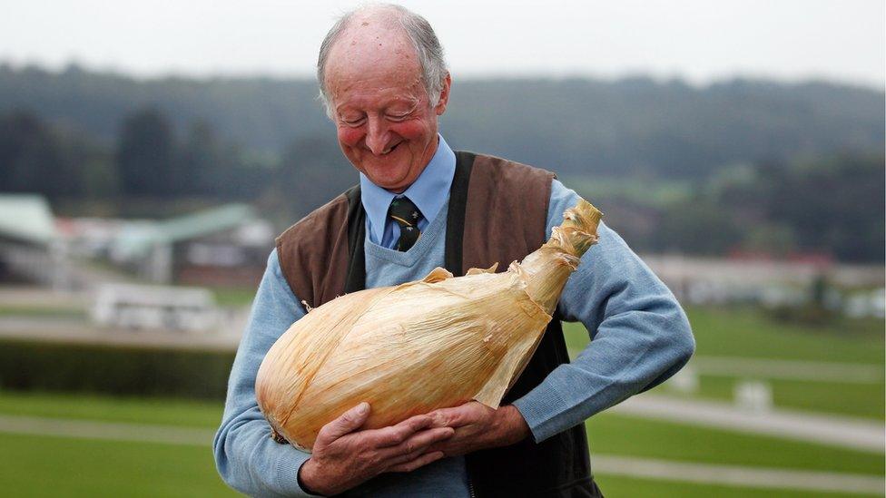 Man holding a Giant Onion