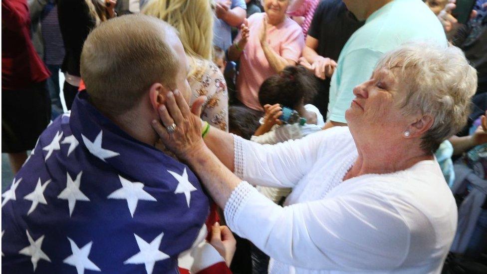 Grandmother hugs grandson