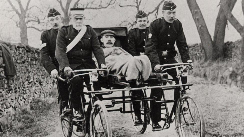 A man in a cycle ambulance from the 1910s