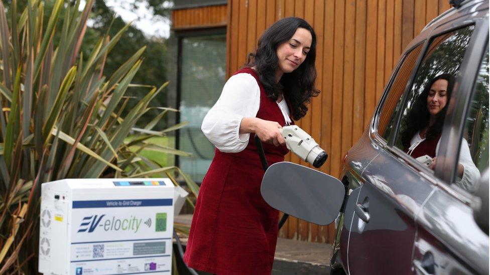 A woman charging her car