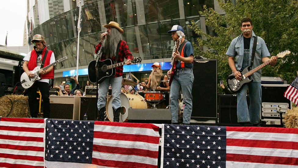 Musicians Chris Shiflett, Dave Grohl, Taylor Hawkins, Nate Mendel and Pat Smear of Foo Fighters perform on the Streets of Kansas City on September 16, 2011 in Kansas City, Missouri.