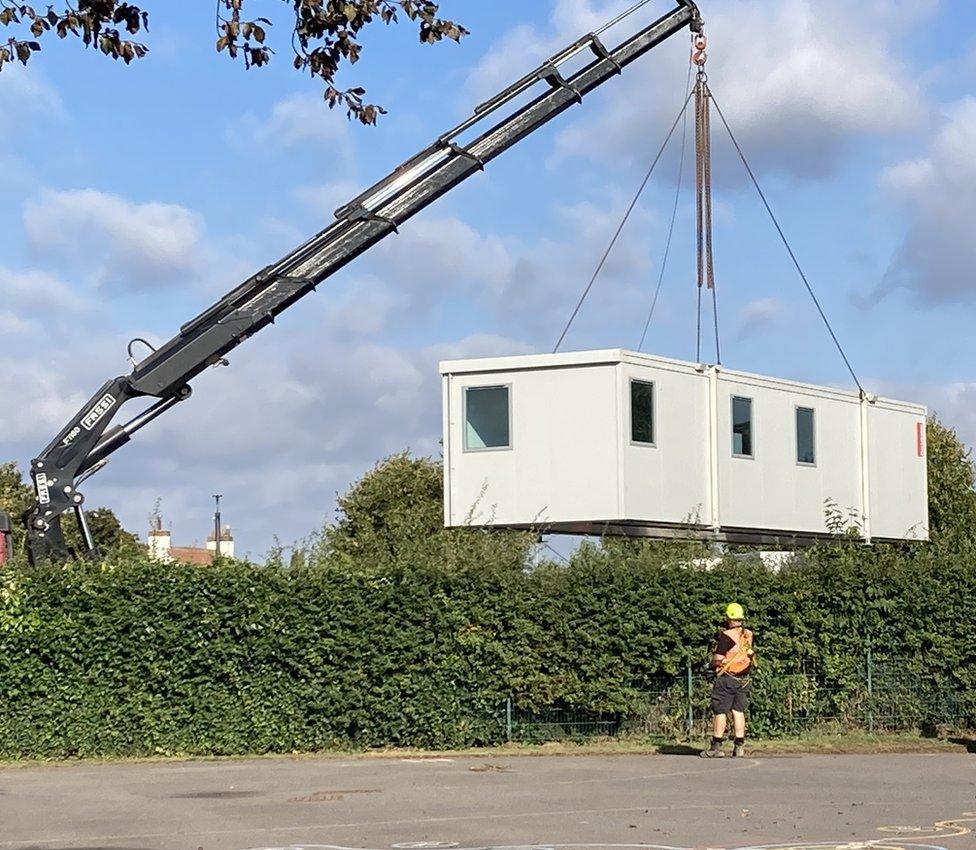 Mobile classroom being placed on the playground of Holy Trinity Catholic Academy, in Newark, Nottinghamshire