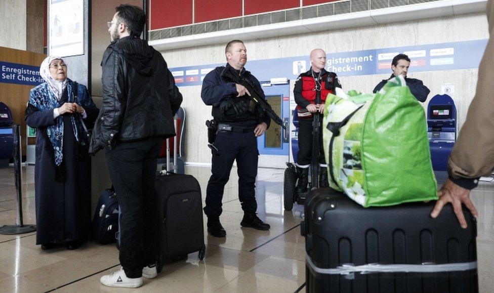 Riot police officer patrol inside Orly airport, south of Paris, as flights began to resume on Saturday 18 March, 2017.