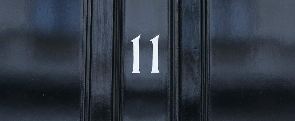 Image shows the front door of 11 Downing Street, the official residence of the Chancellor of the Exchequer