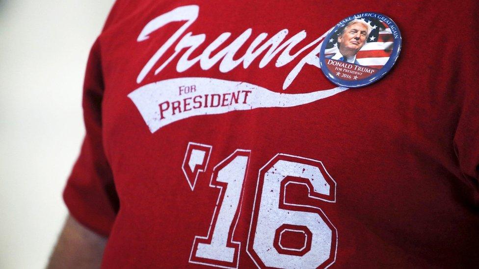 supporter of Republican U.S. presidential candidate Donald Trump wearing a "Trump for President "16" t-shirt listens to the candidate speak at a campaign rally at the airport in Hagerstown, Maryland, U.S.