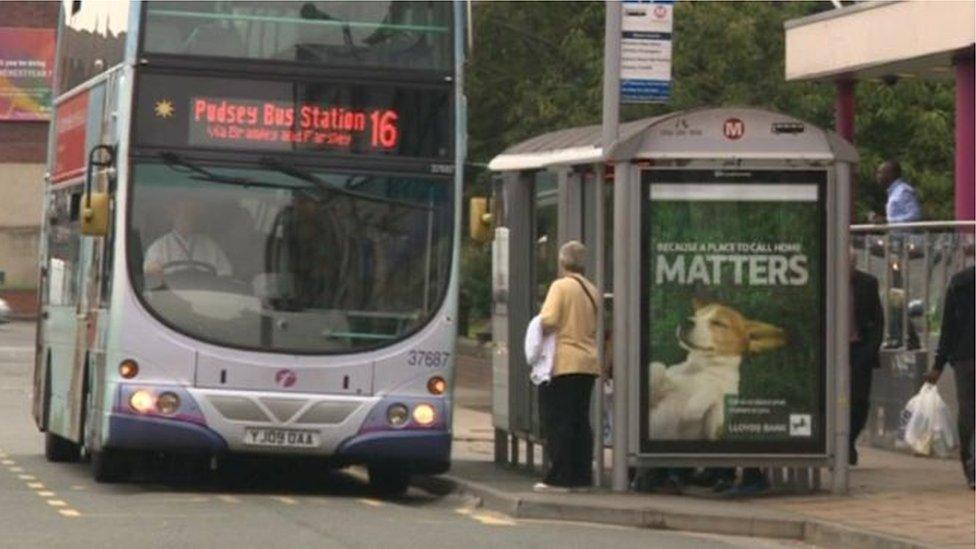 A bus driving through Leeds