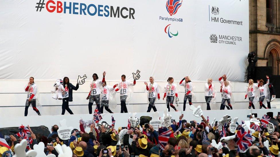Athletes walk out onto the stage in Albert Square in Manchester