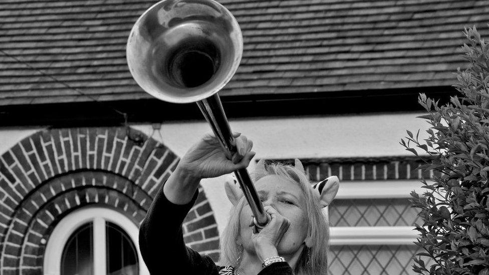 Woman blowing a horn