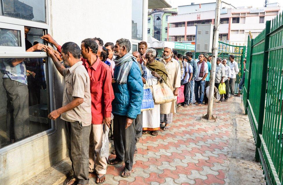 People queue up for breakfast outside the canteen