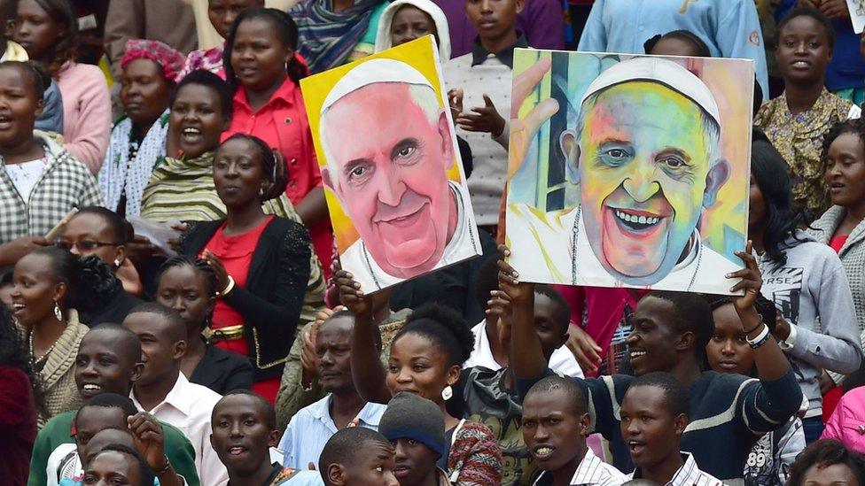 People dance as they await the arrival of Pope Francis at the Kasarani Stadium in Nairobi on 27 November 2015 for a meeting with youths - Kenya