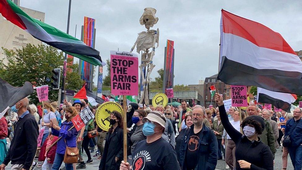 skeleton replica held aloft during protest march