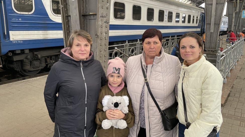 A family at Lviv's train station heading east