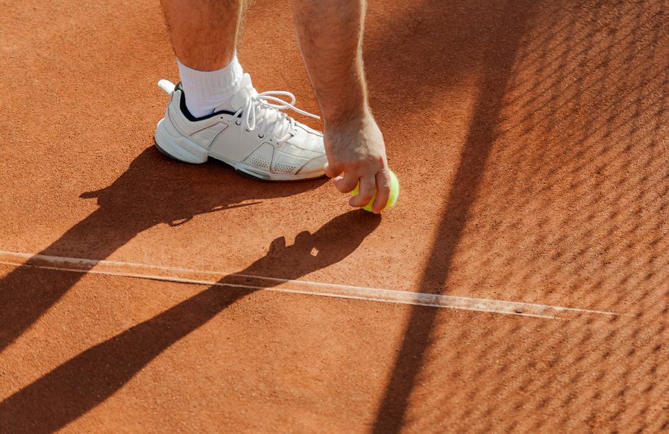 Shadow of tennis player