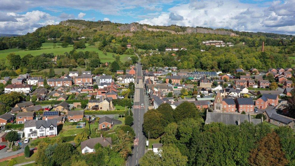 An aerial drone view of the border village of Llanymynech which is split by the border with England, right, and Wales, left