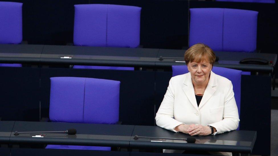 German Chancellor Angela Merkel sits on the government's bench after she took the oath during a swearing-in ceremony