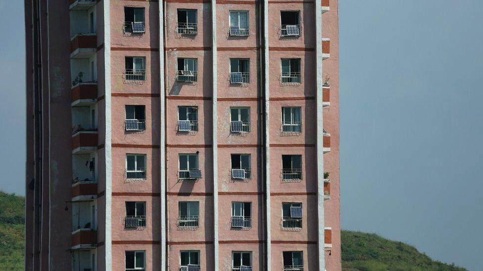 Apartment bloc with several solar panes attached to windows